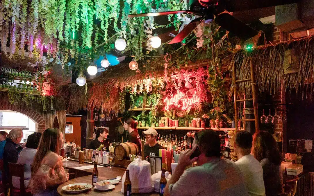 Customers in jungle bird bar during happy hour